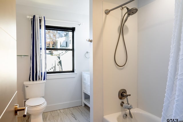 bathroom with shower / bath combo and toilet