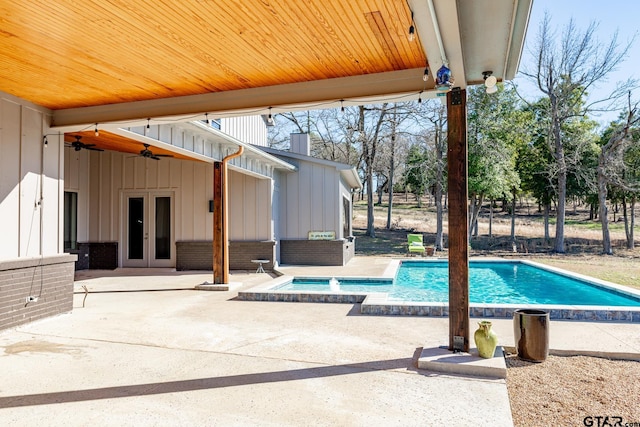 view of pool with a hot tub, a patio, french doors, and ceiling fan