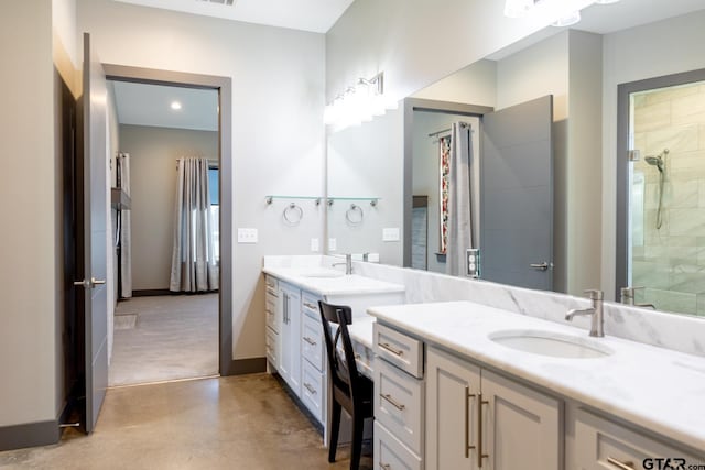 bathroom featuring concrete flooring, vanity, and a tile shower