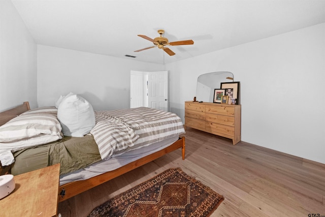 bedroom with ceiling fan and wood-type flooring