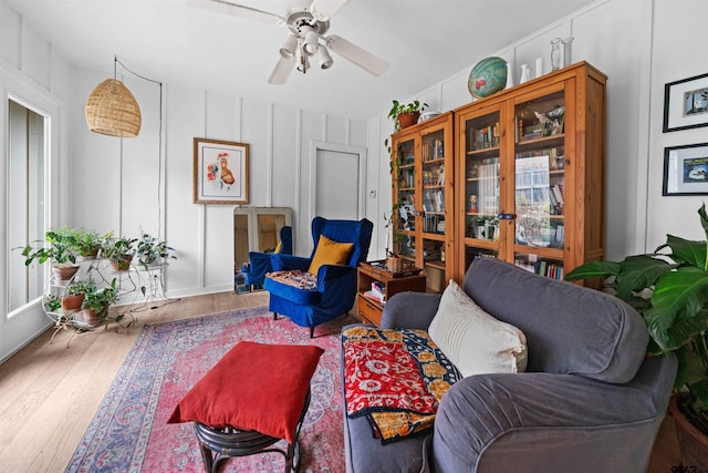 living room featuring hardwood / wood-style floors and ceiling fan