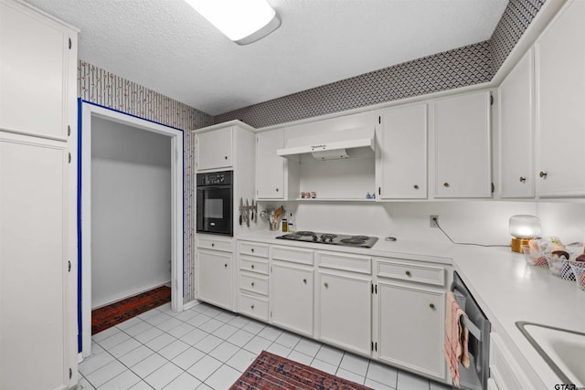 kitchen with white gas stovetop, stainless steel dishwasher, light tile patterned floors, black oven, and white cabinetry