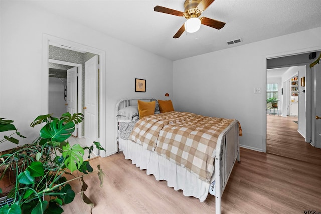 bedroom featuring ceiling fan, a textured ceiling, and hardwood / wood-style flooring