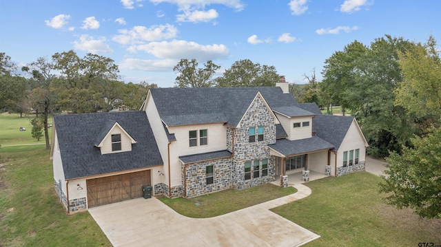 view of front of house featuring a garage and a front lawn