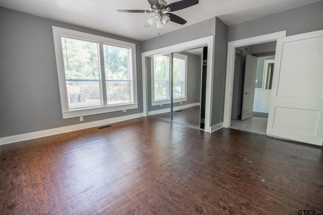 701 W Houston St, Tyler, TX 75702 - unfurnished bedroom with baseboards, wood finished floors, a closet, and a ceiling fan