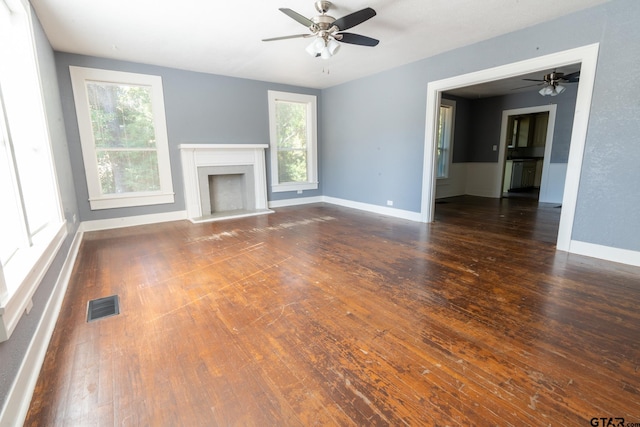 unfurnished living room with dark wood-type flooring and ceiling fan