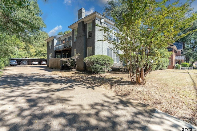 view of property exterior with a carport