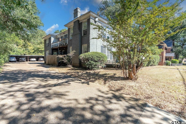 701 W Houston St, Tyler, TX 75702 - view of property exterior with a chimney and a balcony