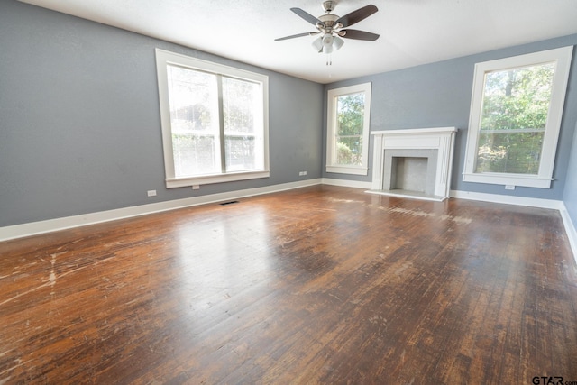 unfurnished living room featuring hardwood / wood-style floors and ceiling fan