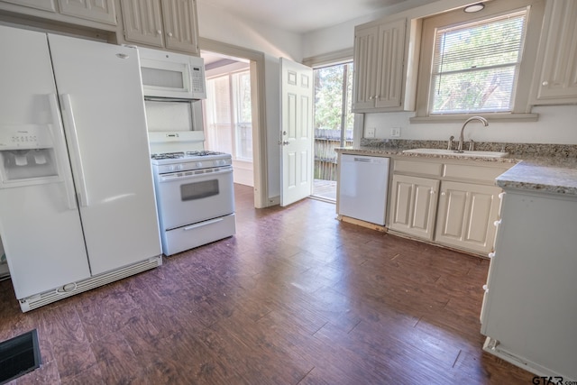 kitchen with white appliances, dark hardwood / wood-style floors, and sink