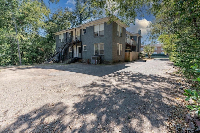 701 W Houston St, Tyler, TX 75702 - back of property with stairway and cooling unit