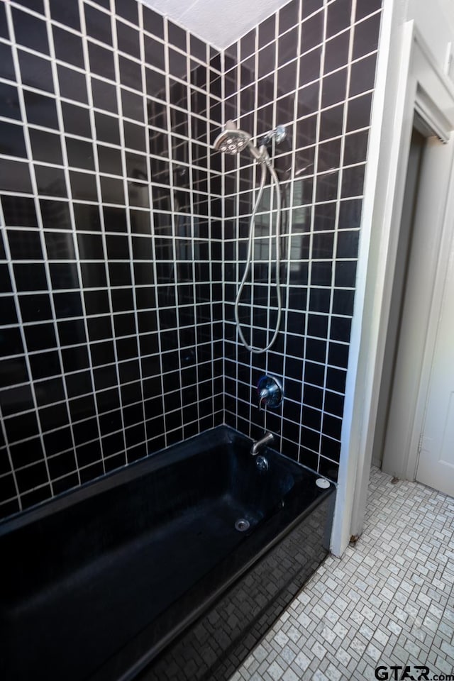 bathroom featuring tile patterned flooring and tiled shower / bath combo