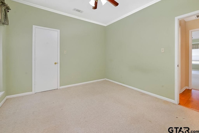 unfurnished room with ceiling fan, carpet floors, and crown molding