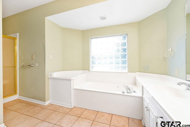 bathroom with plus walk in shower, vanity, and tile patterned floors