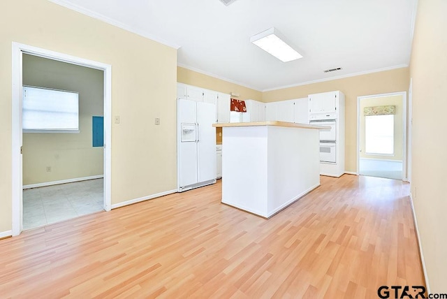 kitchen with white cabinetry, white appliances, ornamental molding, and light wood-type flooring