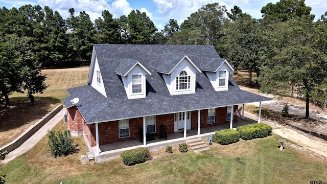 view of front of home featuring a front yard and a porch