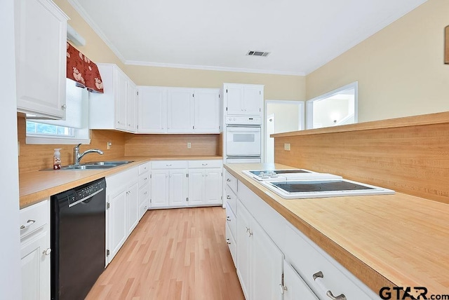 kitchen featuring crown molding, white cabinetry, sink, white appliances, and light hardwood / wood-style flooring