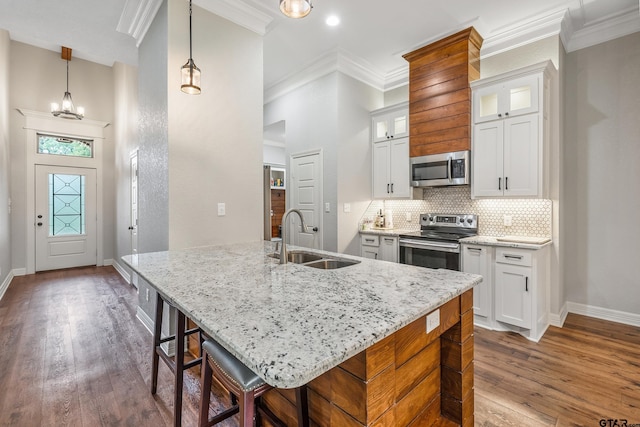20851 Lakeview Dr, Flint, TX 75762 - kitchen with stainless steel appliances, crown molding, dark wood-type flooring, tasteful backsplash, and light stone countertops