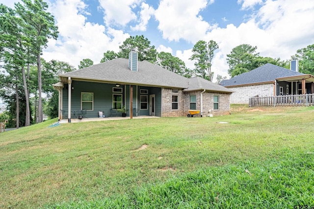 20851 Lakeview Dr, Flint, TX 75762 - back of property with a chimney, a patio, a yard, and brick siding