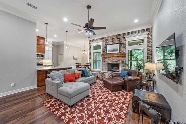 20851 Lakeview Dr, Flint, TX 75762 - living room with dark wood finished floors, a ceiling fan, crown molding, a textured wall, and a fireplace