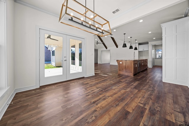 interior space featuring french doors, ornamental molding, vaulted ceiling, ceiling fan, and dark wood-type flooring