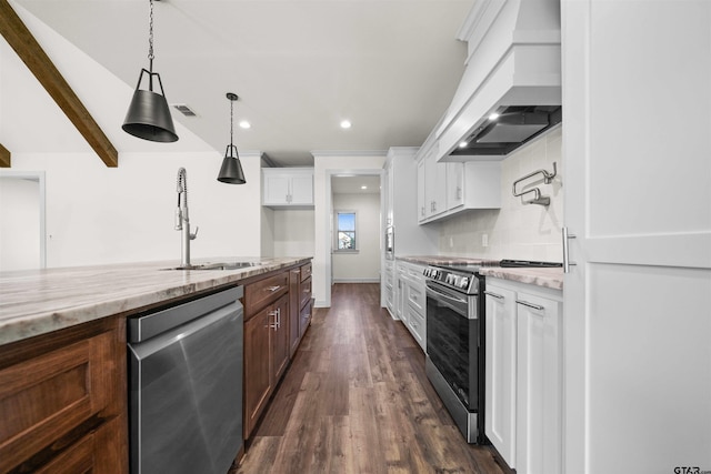 kitchen with backsplash, white cabinets, appliances with stainless steel finishes, light stone counters, and custom range hood