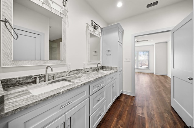 bathroom featuring hardwood / wood-style floors, vanity, and ceiling fan