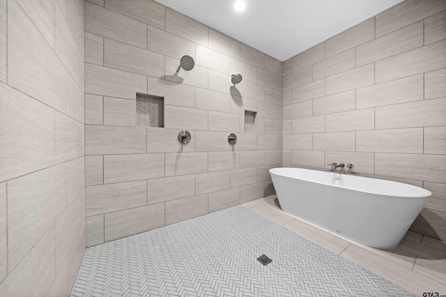 bathroom featuring separate shower and tub, tile patterned floors, and tile walls