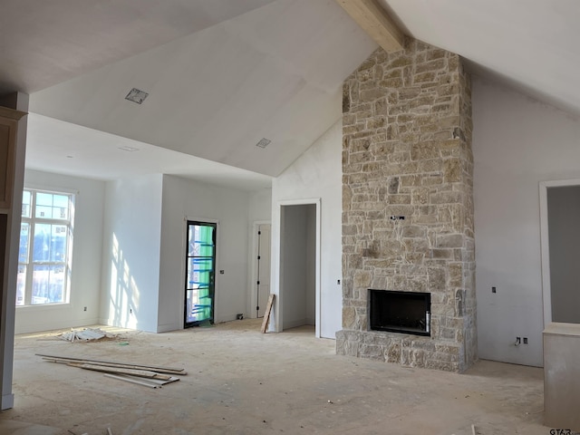 unfurnished living room featuring beamed ceiling, a fireplace, and high vaulted ceiling