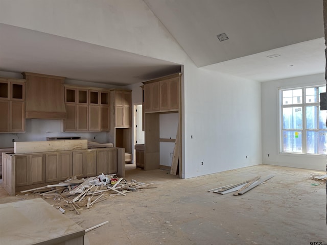 kitchen with premium range hood and lofted ceiling