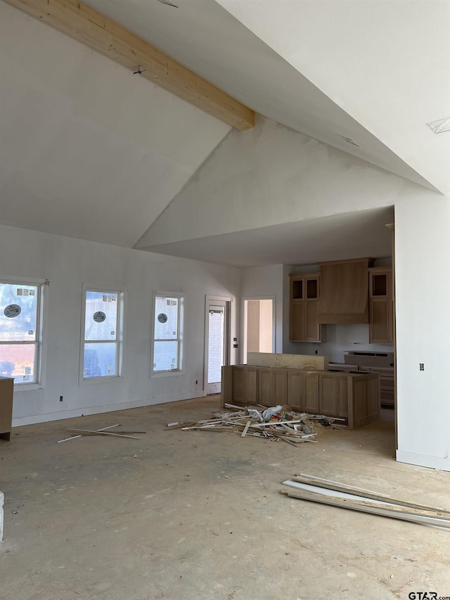 unfurnished living room featuring beamed ceiling and high vaulted ceiling