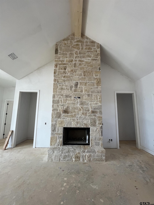 unfurnished living room featuring a fireplace and lofted ceiling with beams