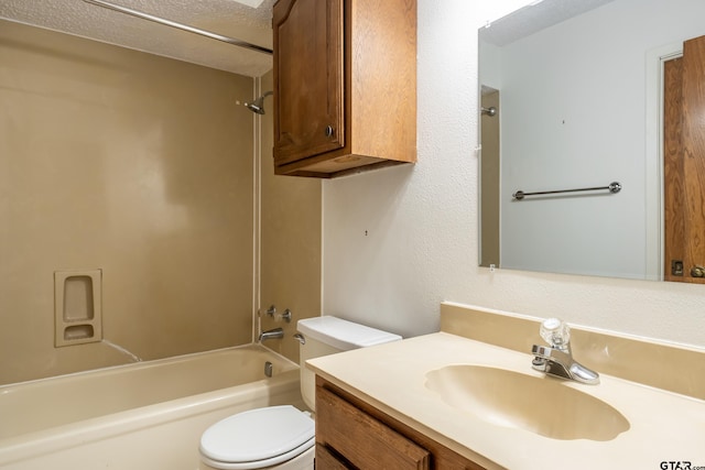 full bathroom with vanity, a textured ceiling, toilet, and tub / shower combination