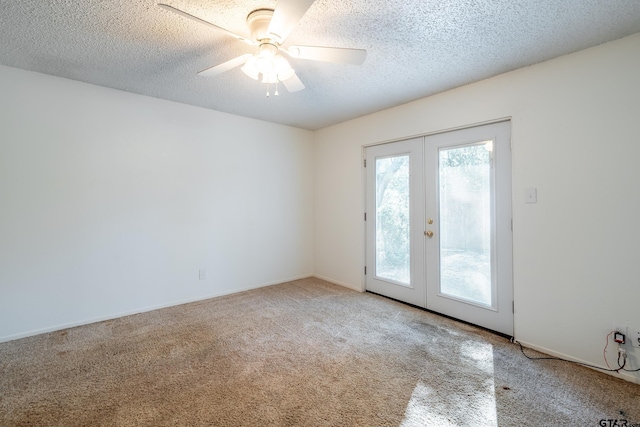 spare room featuring carpet, french doors, ceiling fan, and a textured ceiling