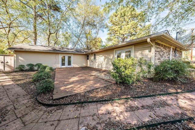 back of house with french doors and a wooden deck