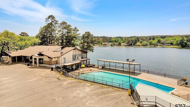 view of pool featuring a water view