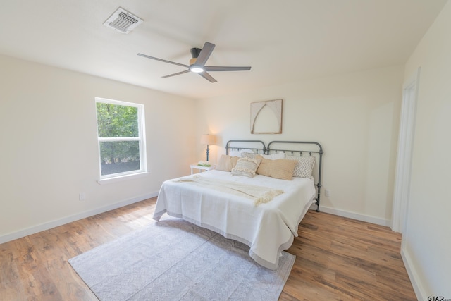 bedroom with hardwood / wood-style floors and ceiling fan