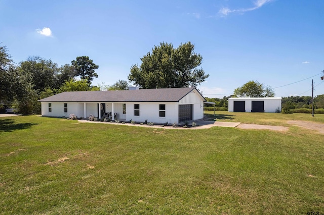 view of front of property featuring a garage and a front lawn