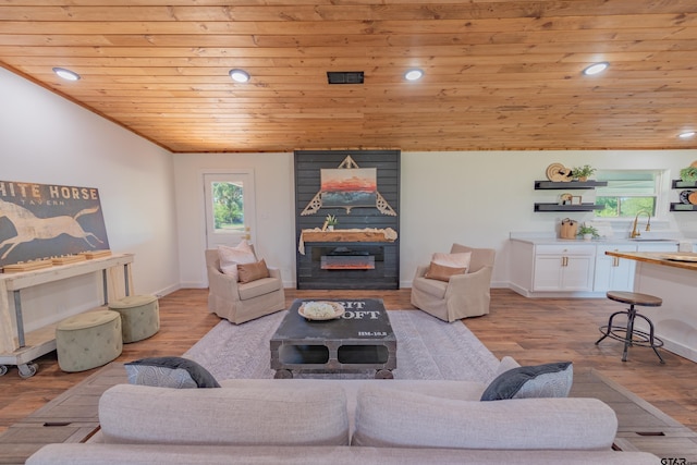 living room with sink, wooden ceiling, and light hardwood / wood-style floors