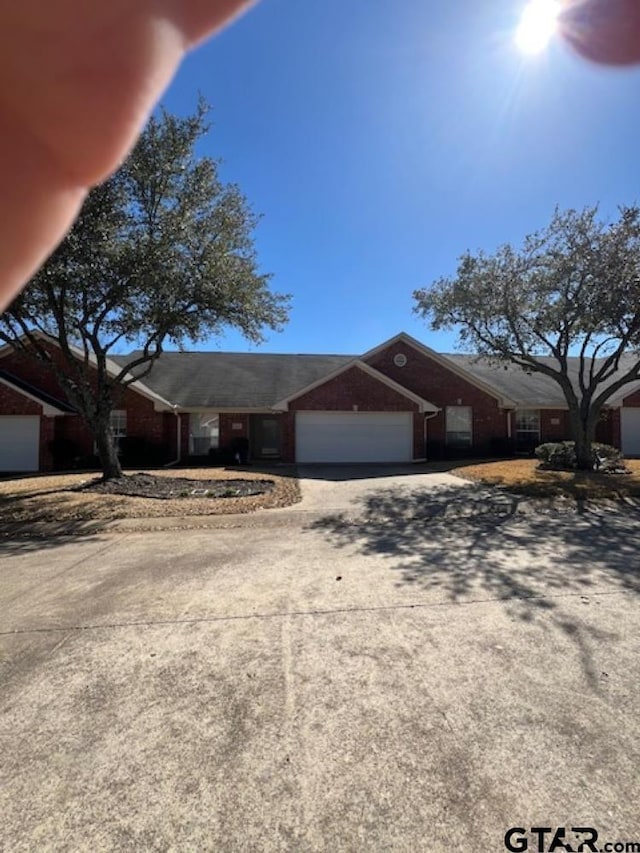 single story home featuring driveway and a garage