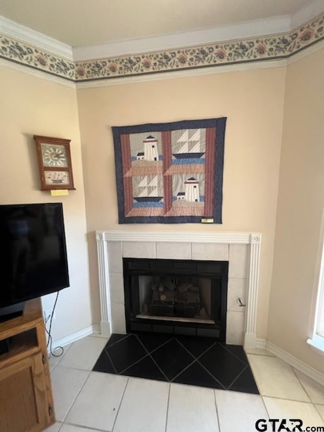 room details featuring baseboards, crown molding, and a tile fireplace