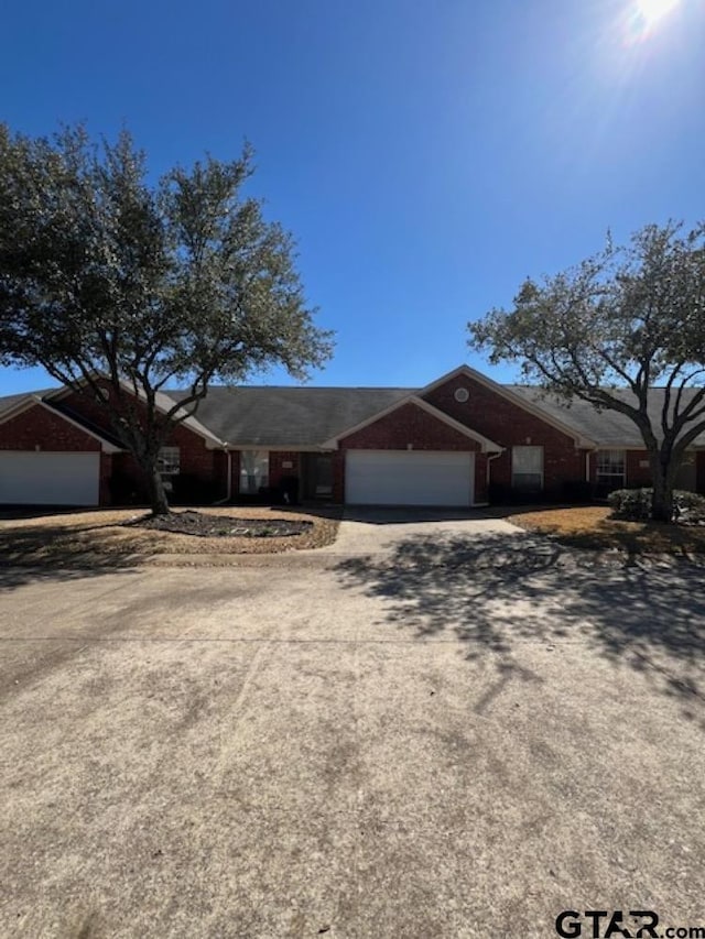 ranch-style home with driveway and a garage