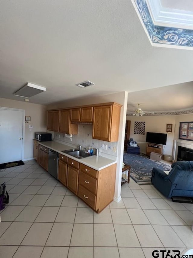 kitchen featuring visible vents, a sink, light countertops, dishwasher, and stainless steel microwave