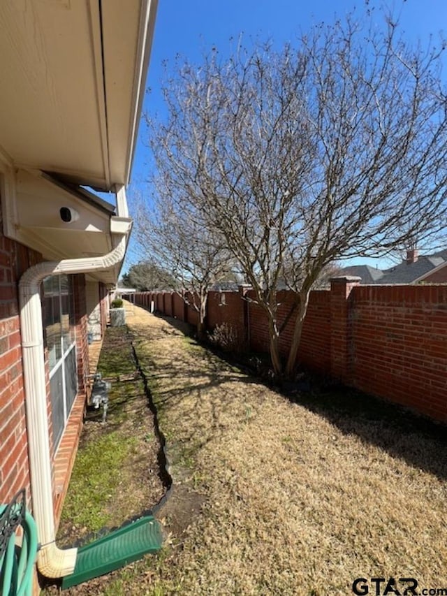 view of yard with a fenced backyard