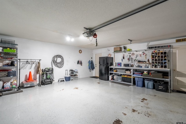 garage featuring a garage door opener and freestanding refrigerator