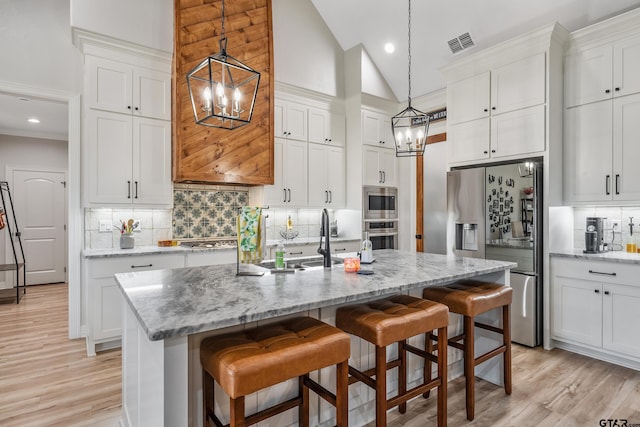 213 Serenity Dr, Bullard, TX 75757 - kitchen with a chandelier, stainless steel appliances, white cabinets, recessed lighting, and high vaulted ceiling