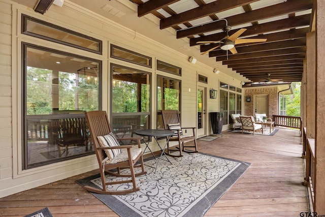wooden terrace featuring a ceiling fan