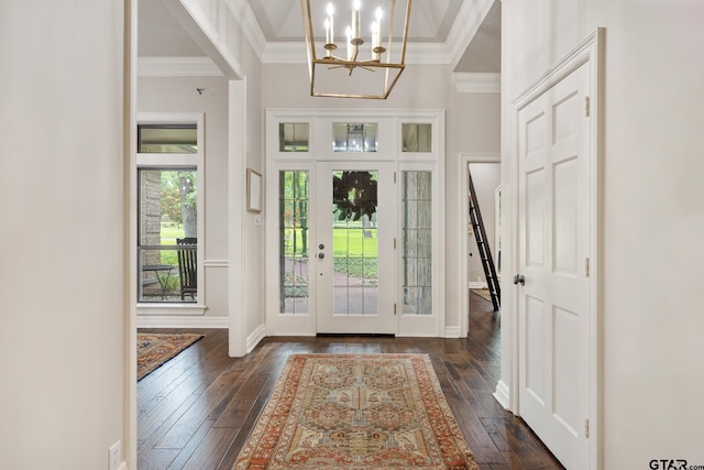 entryway with crown molding, baseboards, dark wood-style floors, and a chandelier