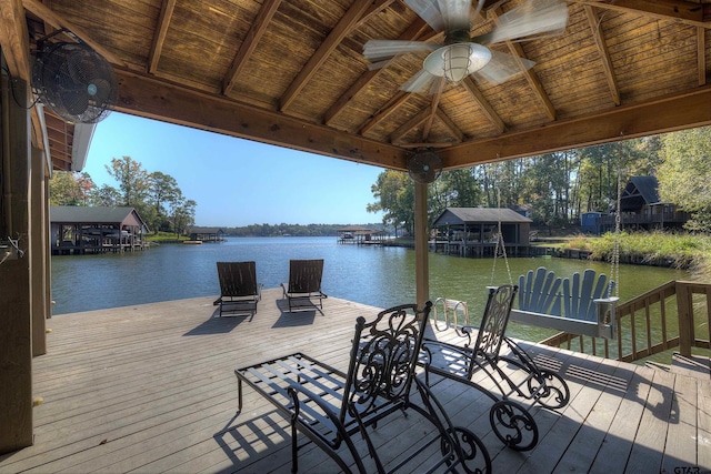 view of dock with a deck with water view and a gazebo