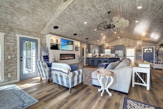 living room featuring lofted ceiling, hardwood / wood-style floors, and wooden ceiling